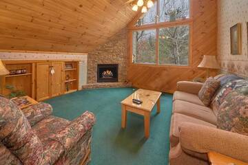 Cabin's upstairs seating with fireplace.